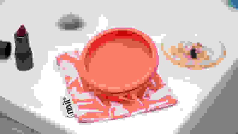nixit menstrual cup on white marble background