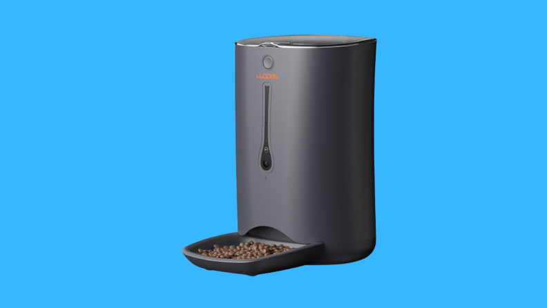 A black pet feeder on a blue background